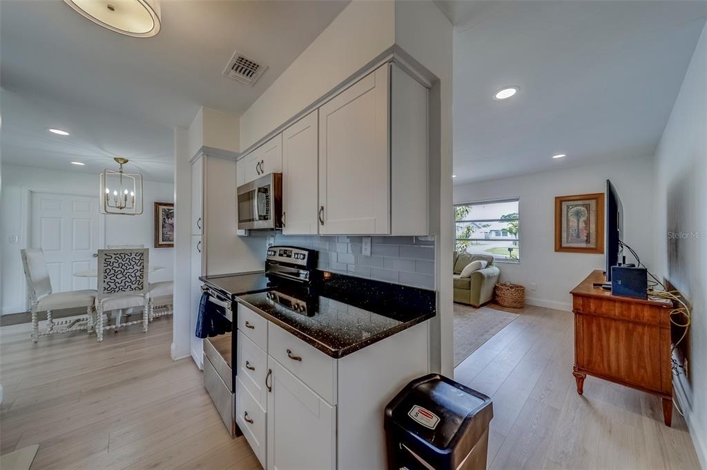 11424 79th Avenue Seminole, FL 33772 - Photo 16 of 62 a kitchen that has a sink and a stove