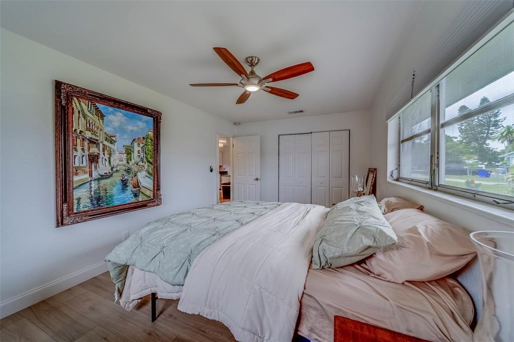 11424 79th Avenue Seminole, FL 33772 - Photo 22 of 62 a spacious bedroom with a bed and a large window