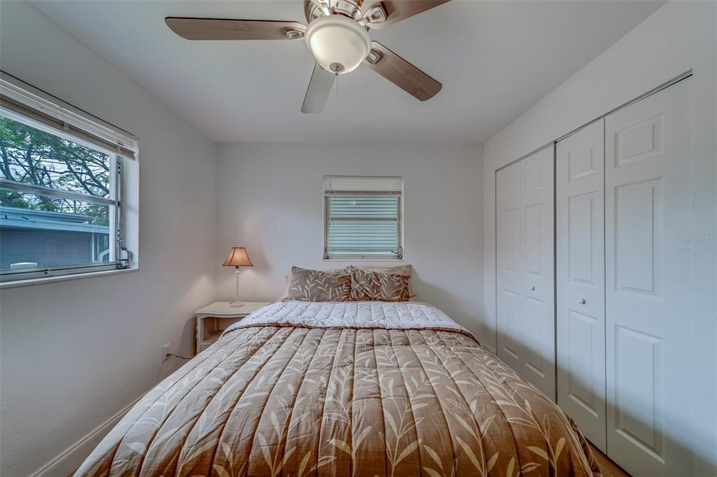 11424 79th Avenue Seminole, FL 33772 - Photo 29 of 62 a bedroom with a bed and large windows