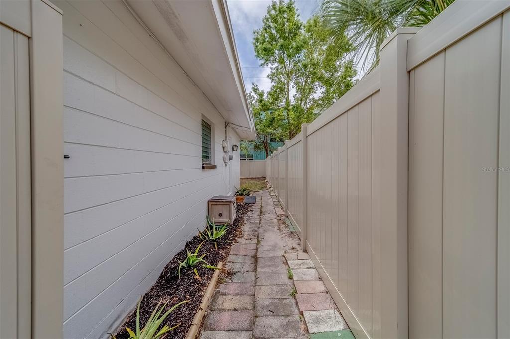 11424 79th Avenue Seminole, FL 33772 - Photo 37 of 62 a view of a pathway with a potted plants