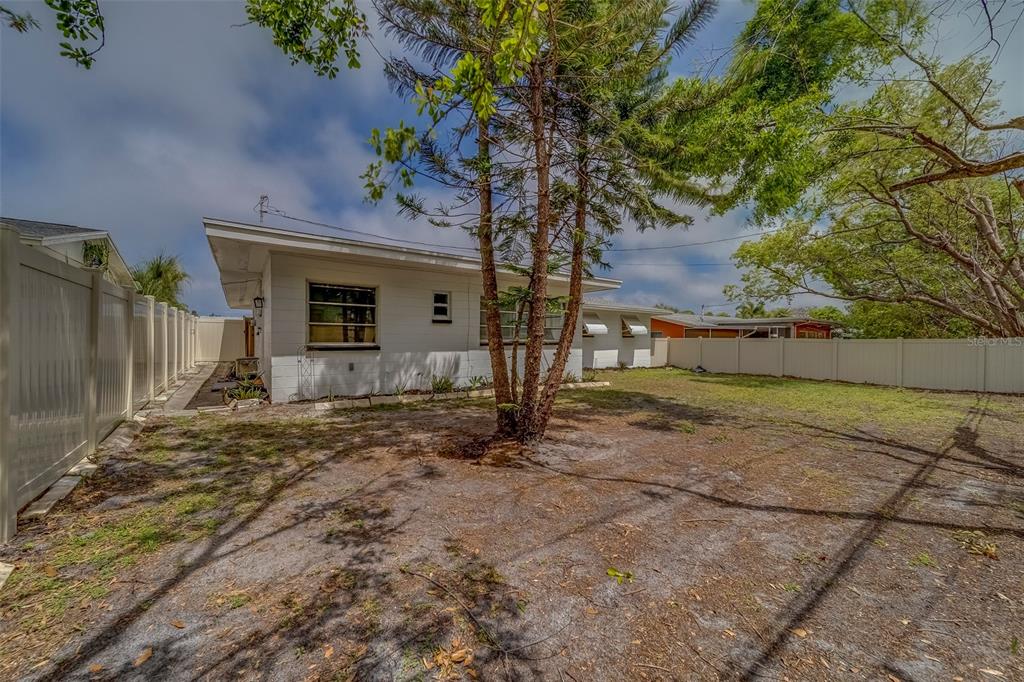 11424 79th Avenue Seminole, FL 33772 - Photo 40 of 62 a view of a house with backyard and a tree