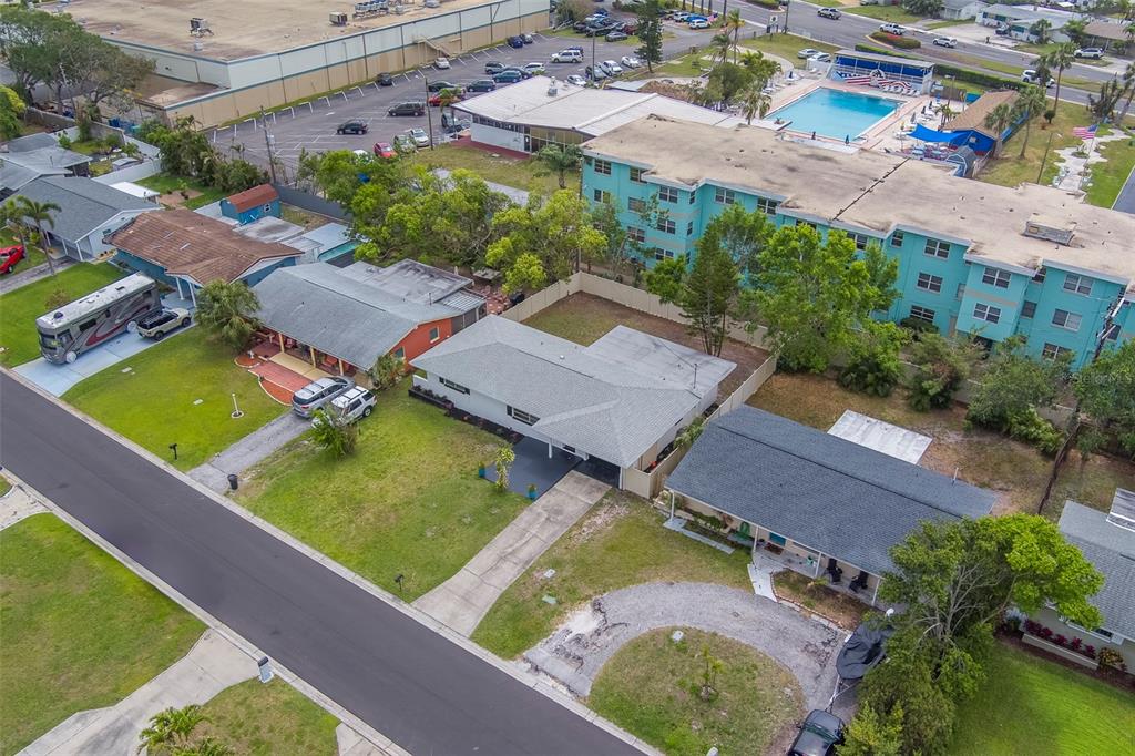 11424 79th Avenue Seminole, FL 33772 - Photo 49 of 62 an aerial view of a house with a garden and swimming pool