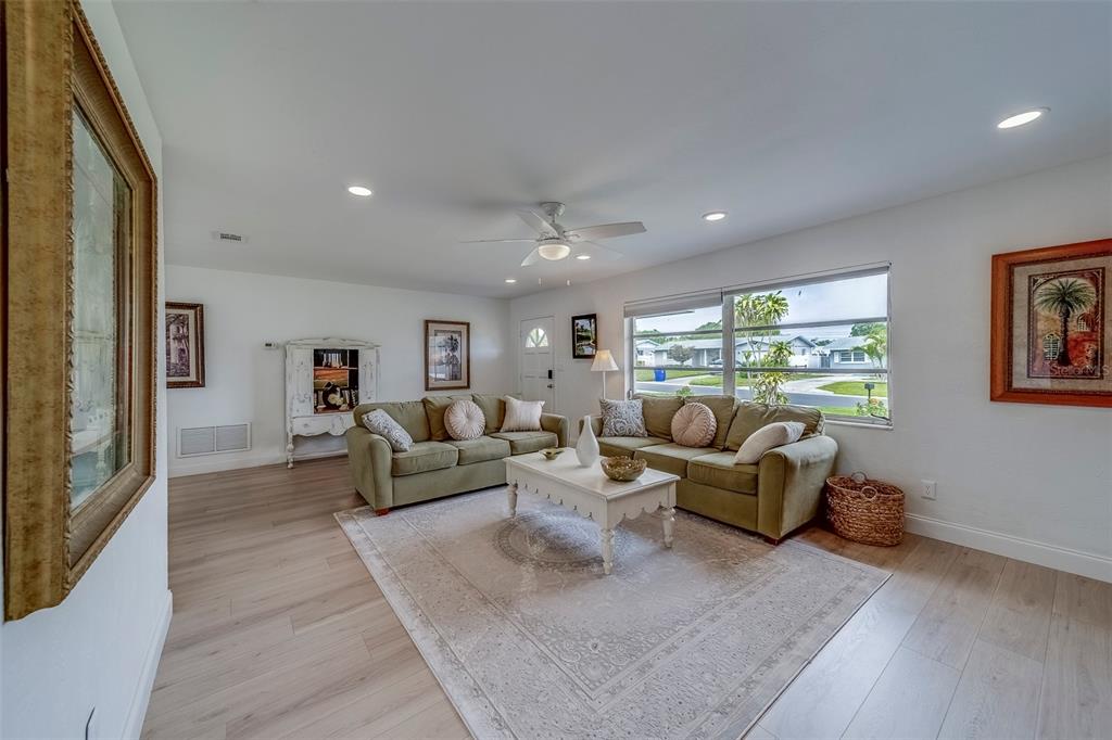 11424 79th Avenue Seminole, FL 33772 - Photo 6 of 62 a living room with furniture and a window
