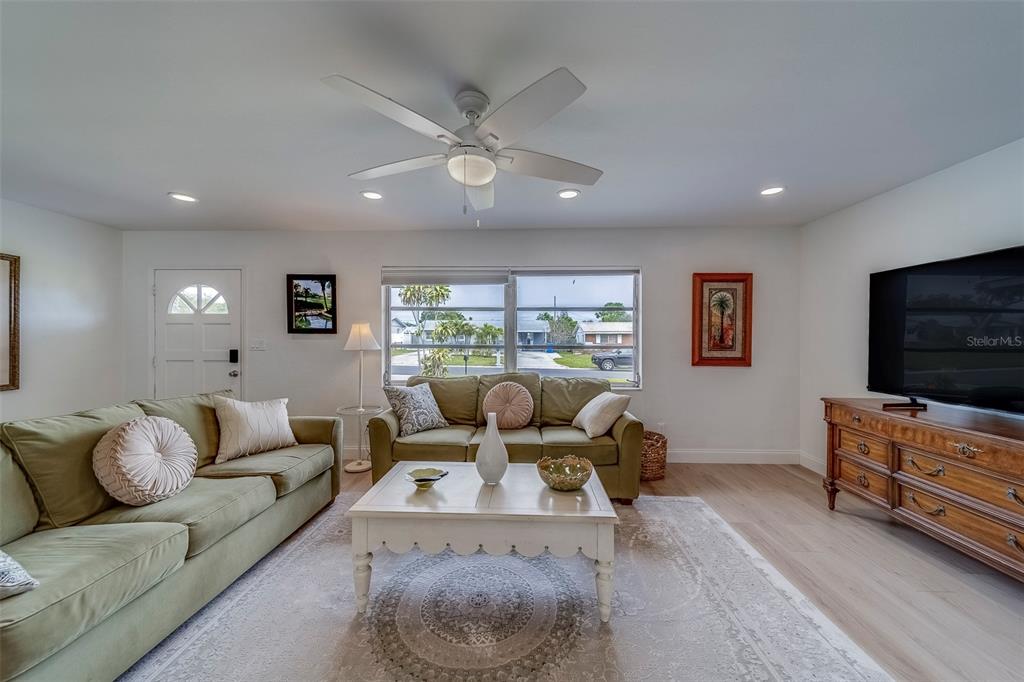 11424 79th Avenue Seminole, FL 33772 - Photo 7 of 62 a living room with furniture and a flat screen tv