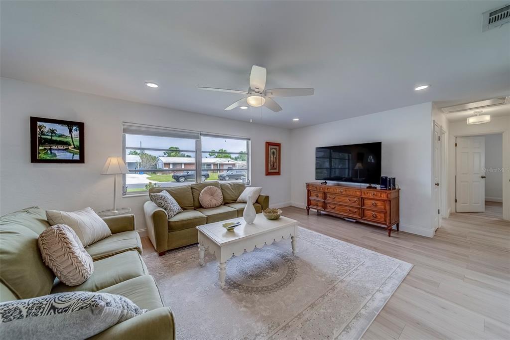 11424 79th Avenue Seminole, FL 33772 - Photo 8 of 62 a living room with furniture and a flat screen tv