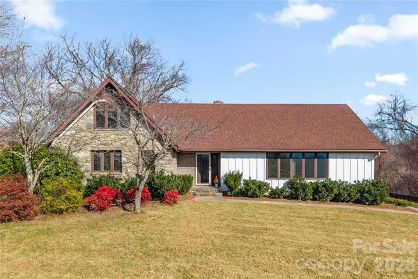 a front view of a house with porch and garden