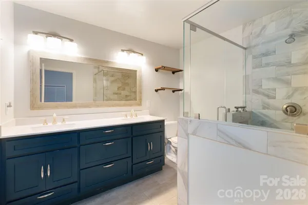 a spacious bathroom with a tub sink and mirror