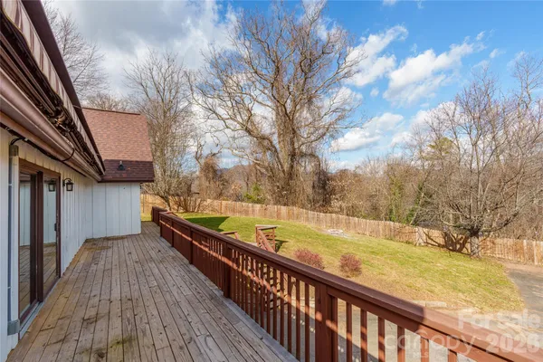 a view of balcony with wooden floor and fence