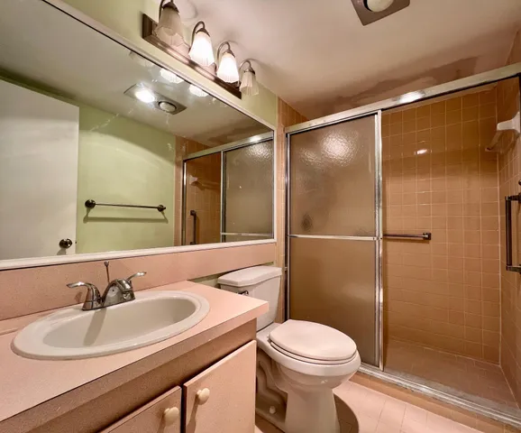 a bathroom with a sink toilet and shower