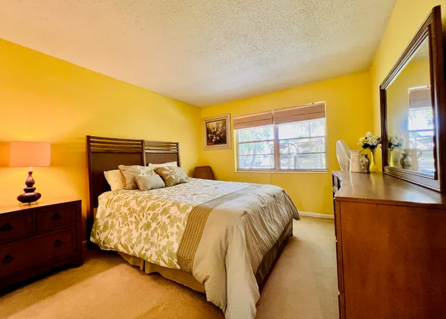 a bed sitting in a bedroom next to a window