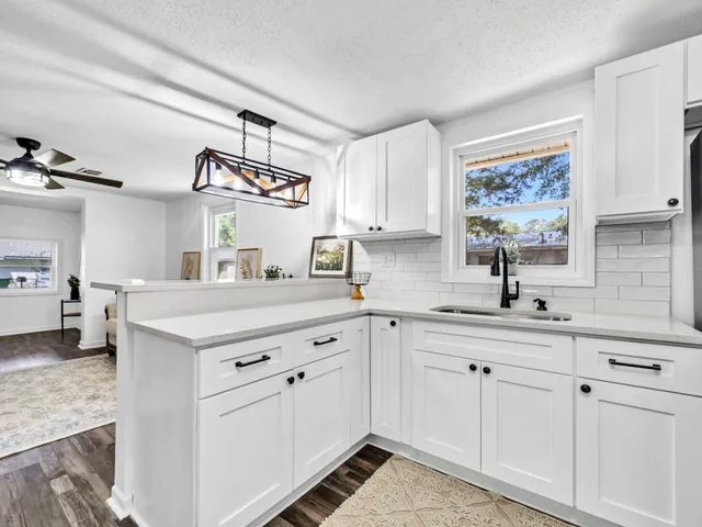 a kitchen with cabinets and window