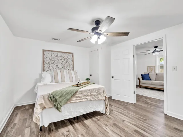 a bedroom with a bed and a chandelier