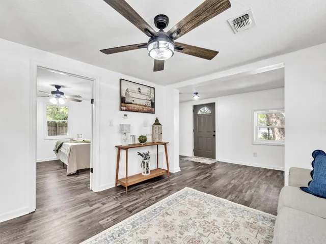 a living room with furniture and a wooden floor
