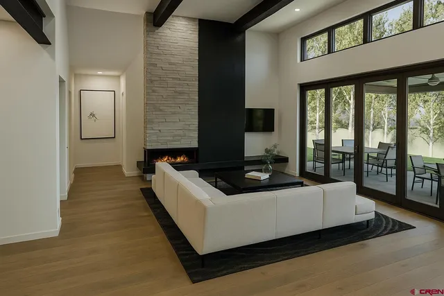 a living room with furniture and a floor to ceiling window