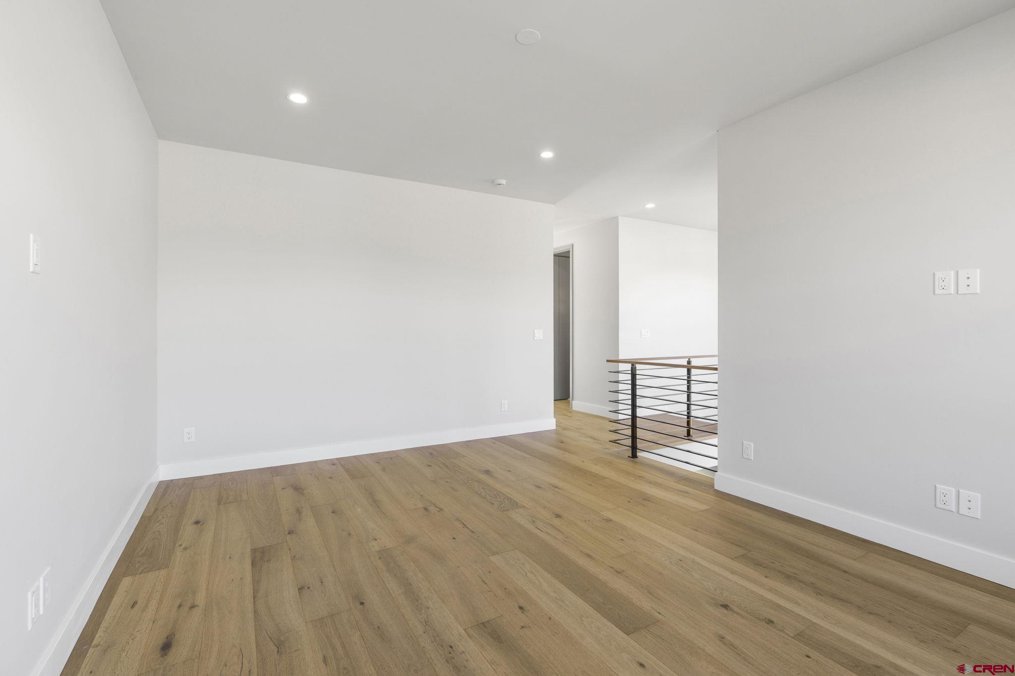 102 Elkview Court Durango, CO 81301 - Photo 36 of 45 a view of an empty room with wooden floor and a window