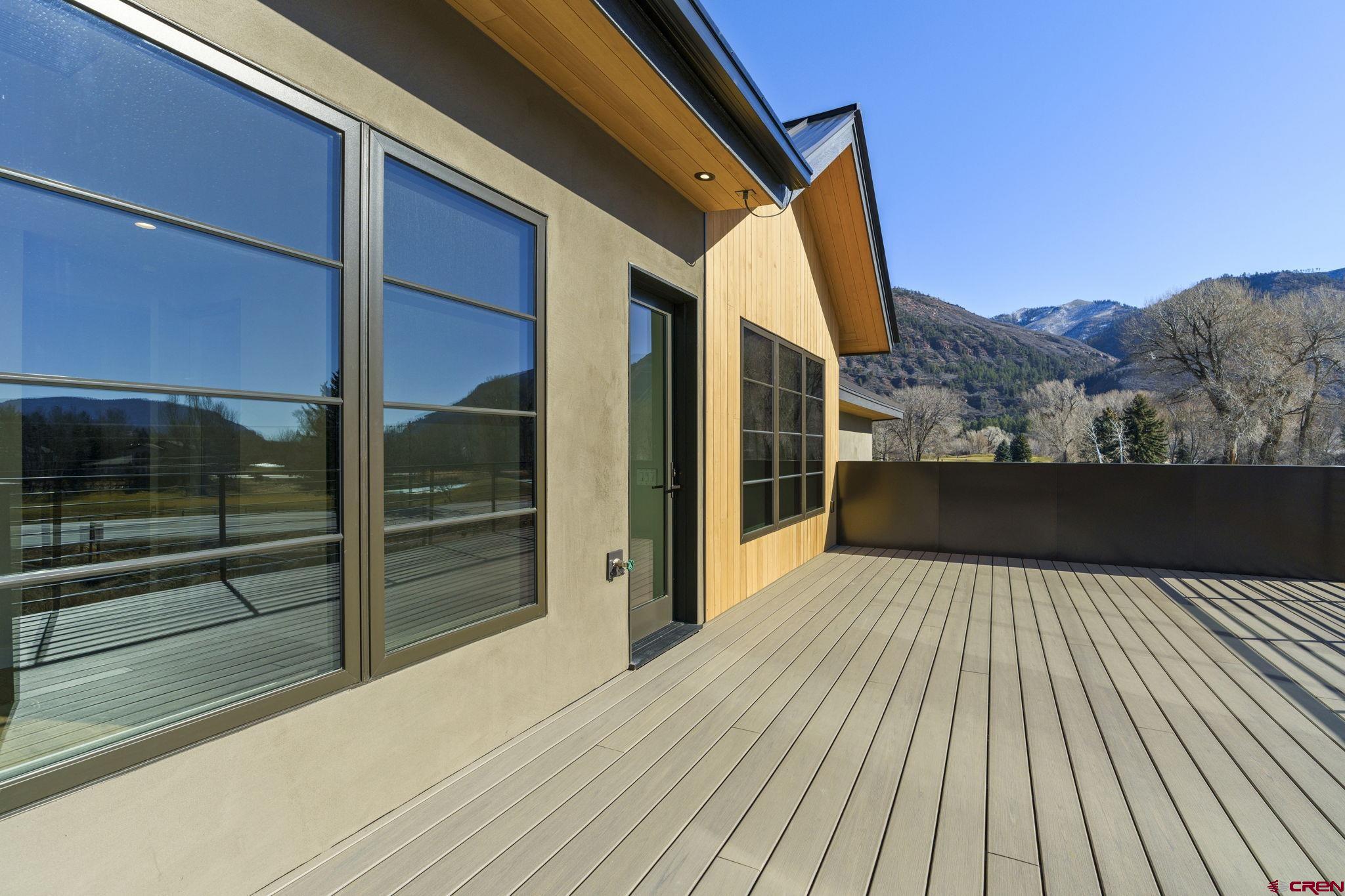 102 Elkview Court Durango, CO 81301 - Photo 41 of 45 a view of balcony with a floor to ceiling window and wooden floor