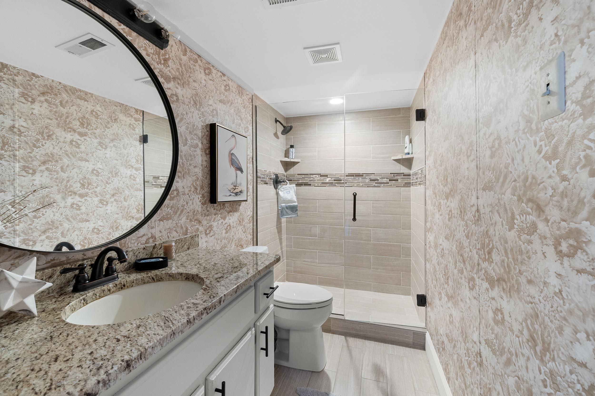 11 Cr 452 Road Iuka, MS 38852 - Photo 23 of 37 a bathroom with a granite countertop sink a toilet and a mirror