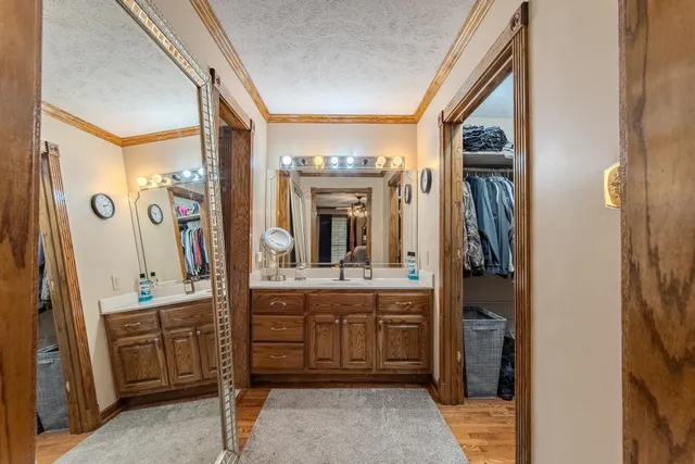 a large bathroom with a double vanity sink a large mirror and a shower
