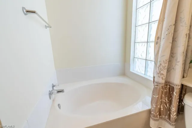 a white bath tub sitting next to a window