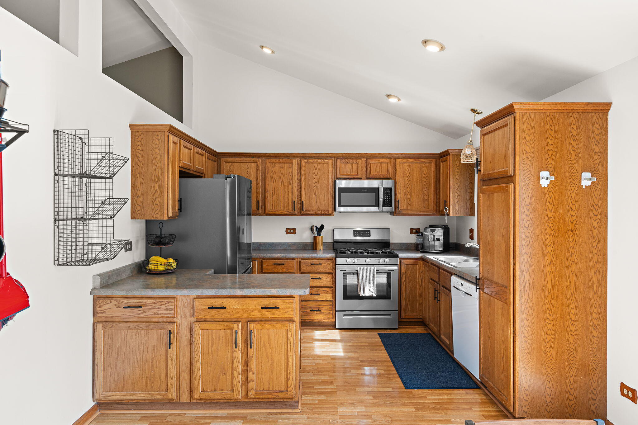 8987 Calhoun Place Crown Point, IN 46307 - Photo 8 of 28 a kitchen with stainless steel appliances granite countertop a refrigerator and stove