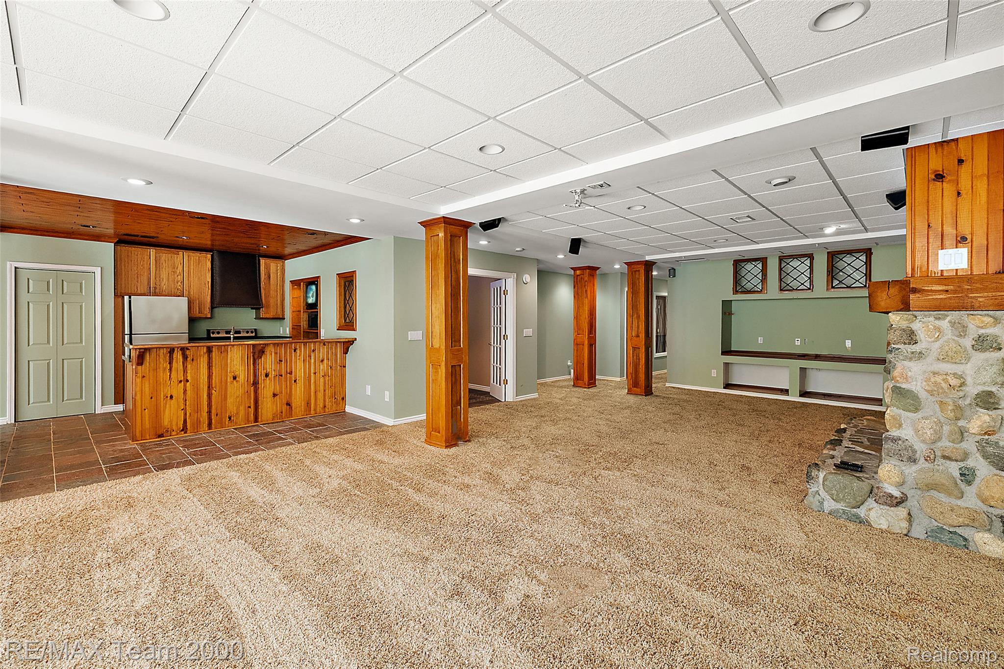 630 Sheldon Court Rochester, MI 48306 - Photo 71 of 94 Unfurnished living room featuring dark carpet, a drop ceiling, dark tile patterned floors, and recessed lighting