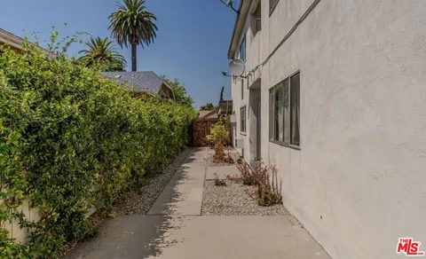 a view of a pathway besides a house