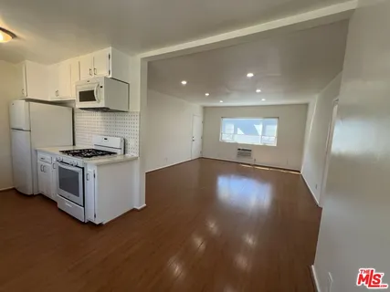 a view of kitchen and entryway with wooden floor