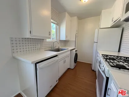 a kitchen with sink cabinets and stove