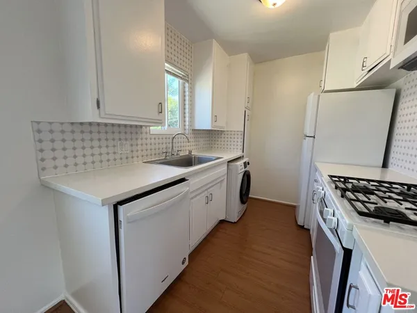 a kitchen with sink cabinets and stove