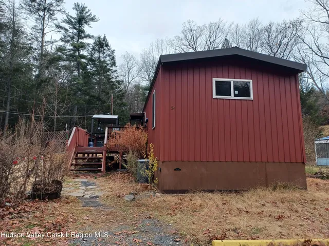 a backyard of a house with bicycles parked and swing