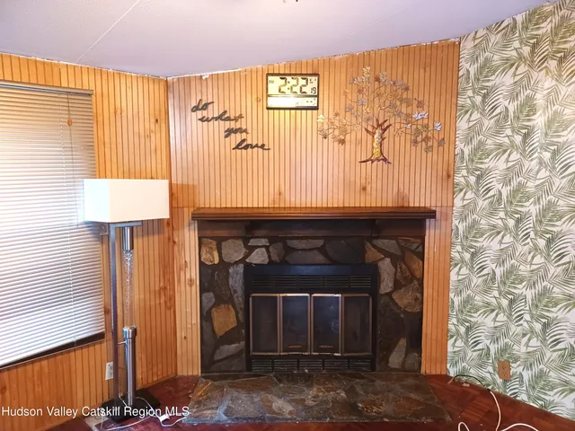 a living room with a fireplace and a window