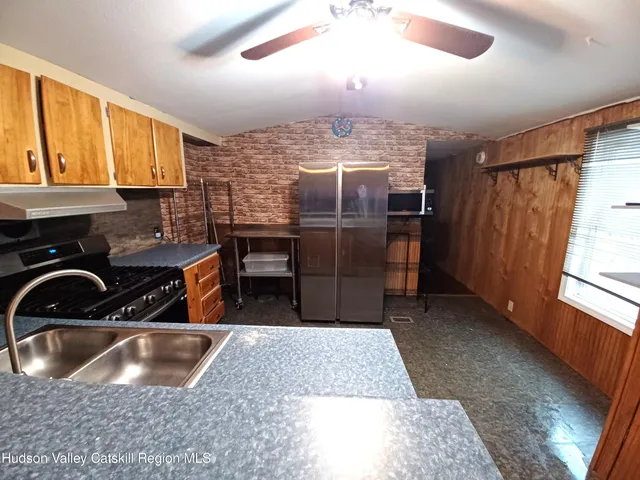 a kitchen with a stove a sink and a refrigerator