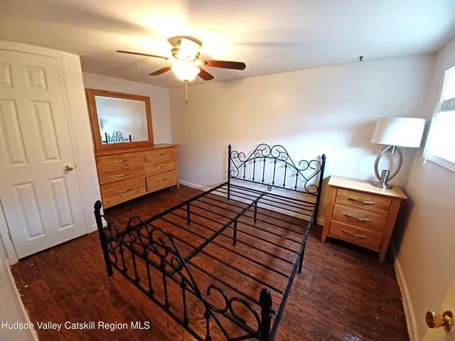 a bedroom with furniture and wooden floor