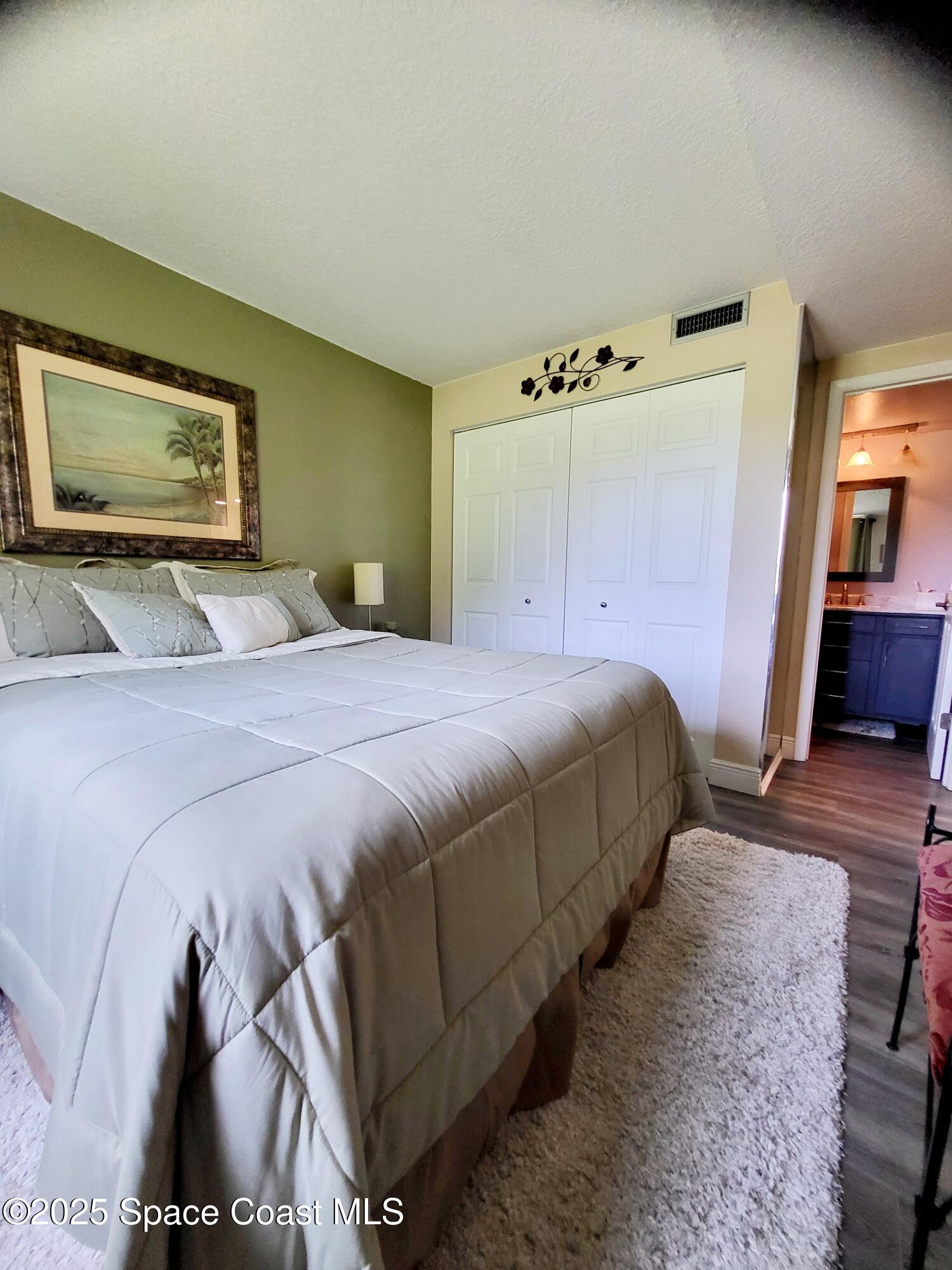 145 Augusta Way Melbourne, FL 32940 - Photo 16 of 28 a bedroom with a bed and a flat screen tv