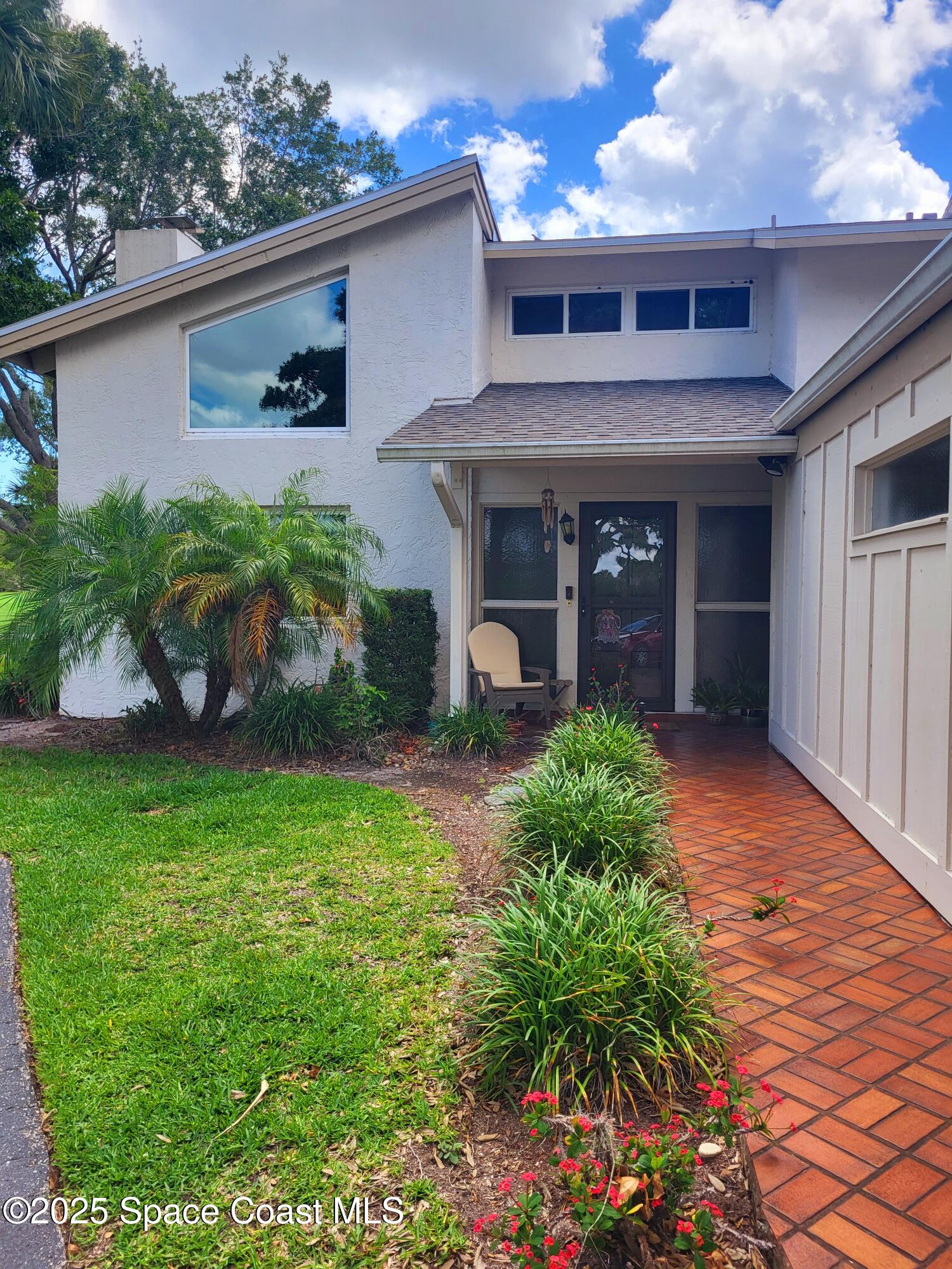 145 Augusta Way Melbourne, FL 32940 - Photo 2 of 28 a front view of a house with garden