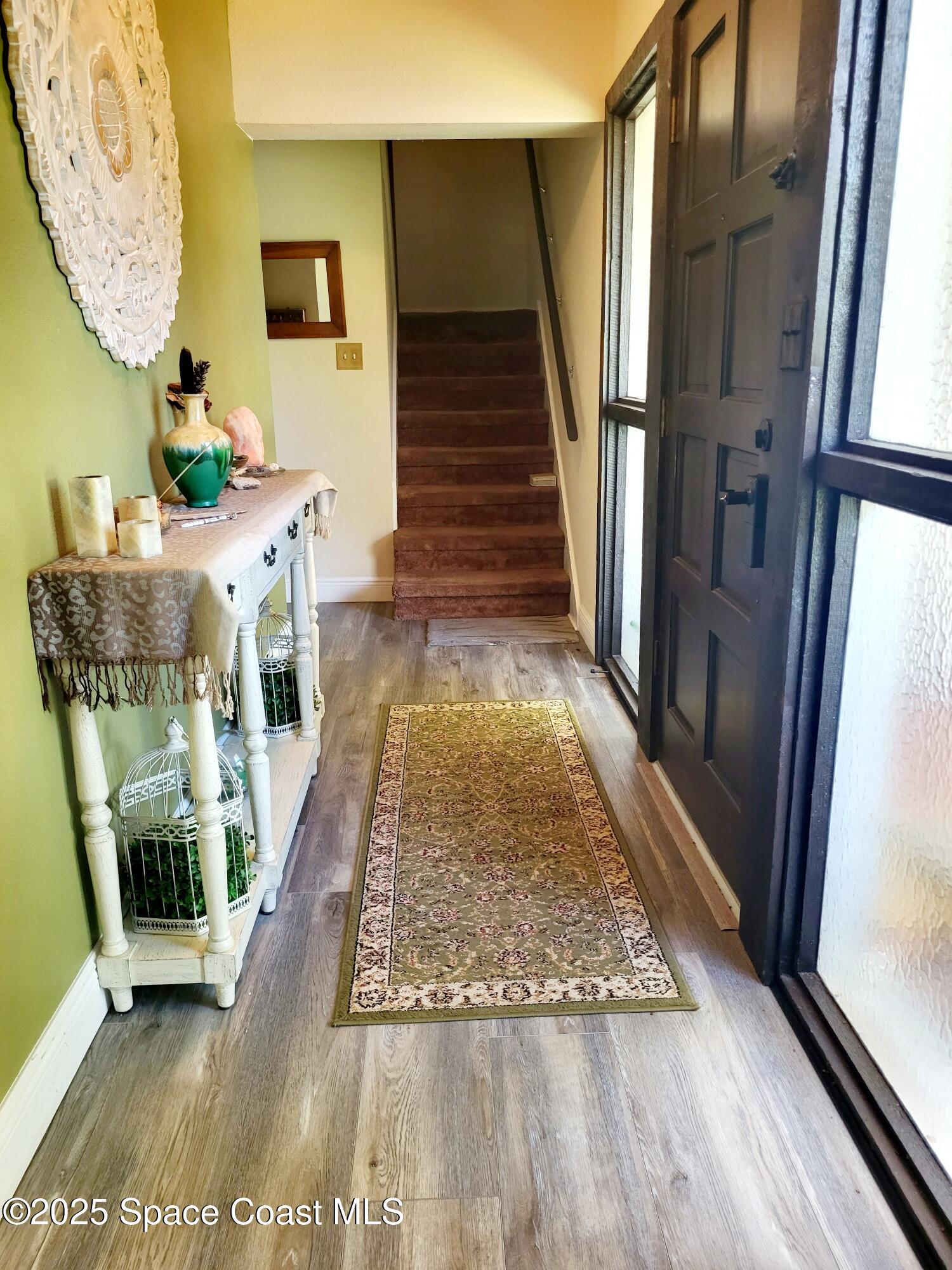 145 Augusta Way Melbourne, FL 32940 - Photo 3 of 28 a view of entryway and hall with wooden floor