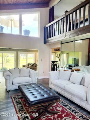 a living room with furniture fireplace and a window