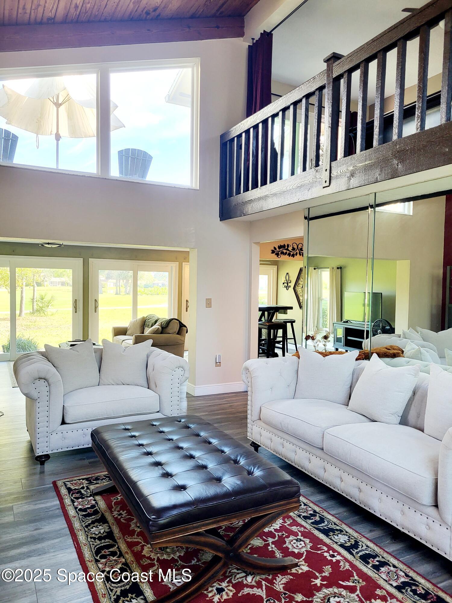 145 Augusta Way Melbourne, FL 32940 - Photo 5 of 28 a living room with furniture fireplace and a window