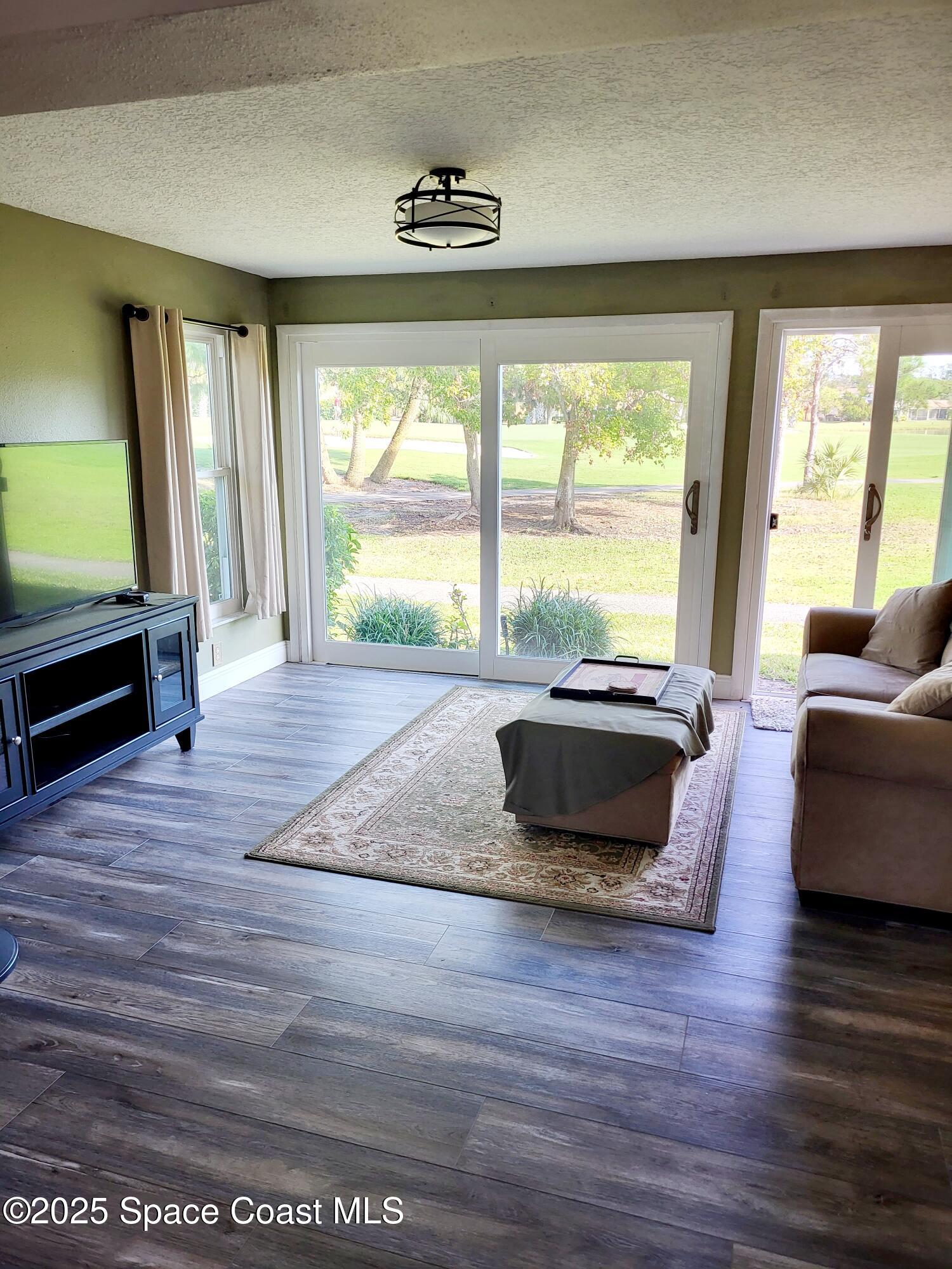 145 Augusta Way Melbourne, FL 32940 - Photo 8 of 28 a living room with furniture and a large window