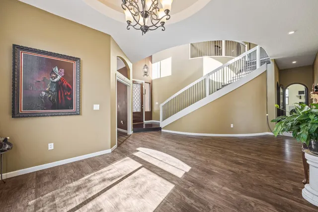 a bedroom with furniture and a large window