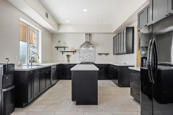 a kitchen with stainless steel appliances a sink stove and cabinets