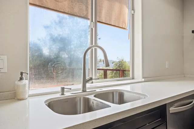 a view of a bedroom with wooden floor & windows