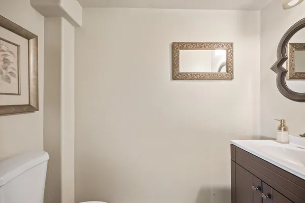 a bedroom with a bed a couch and a dresser with wooden floor