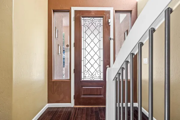 a view of entryway and hall with wooden floor