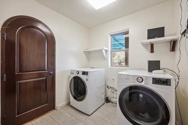 a bathroom with a sink a toilet a mirror and shower