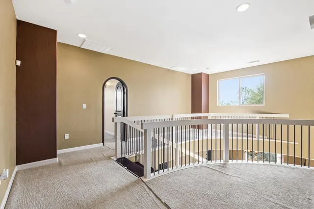 a bathroom with a tub a sink and a window