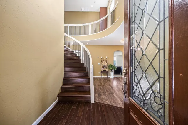 a view of entryway and hall with wooden floor