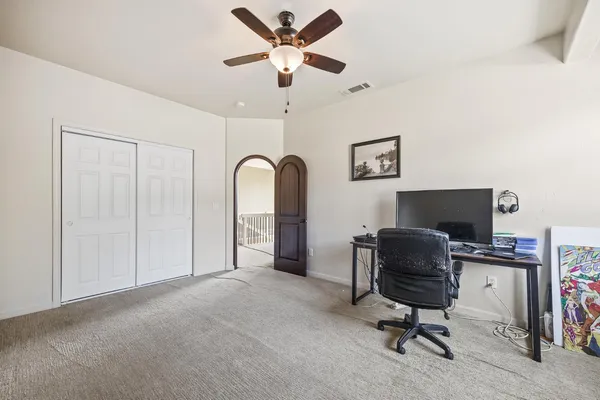 an aerial view of a house with a yard and large tree