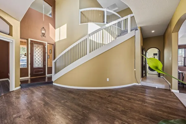 a view of a hallway view with wooden floor and furniture