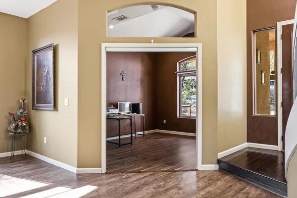 a view of a workspace with wooden floor and a bathroom